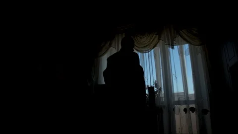 Silhouette of a man dressed in the room Stock Footage 91872014