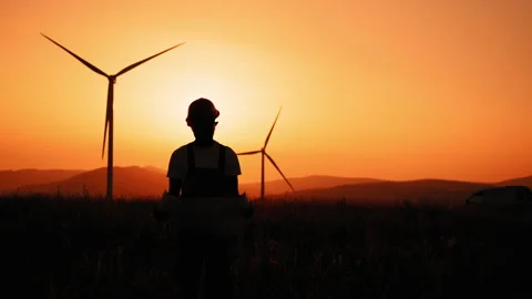 Silhouette man engineer in hard hat stand look at camera holds a large blueprint 스톡 동영상 170660210