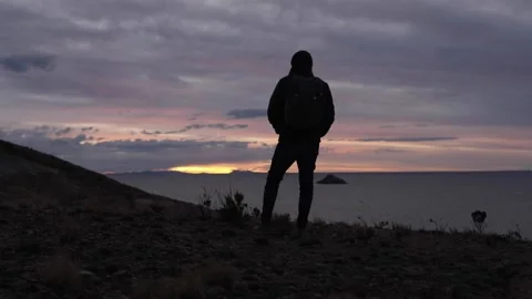 Silhouette of man enjoying sunset at Isla del Sol, Bolivia Stock Footage 197302256