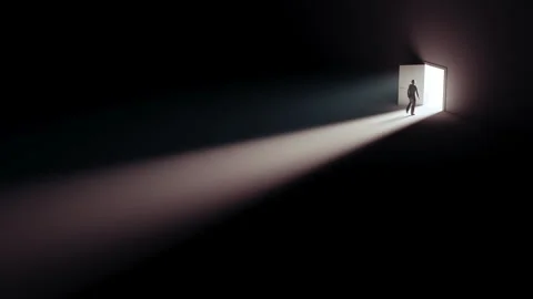 Silhouette of a man entering an open door in rays of light Vídeo Stock 314776799