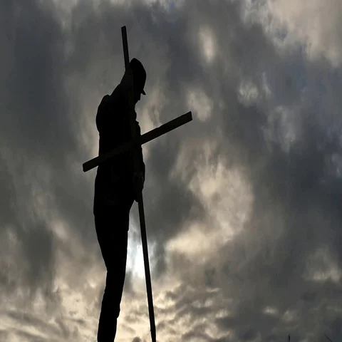 Silhouette of Man fixes the cross - dramatic concept - partially slow motion Stock Footage 69333520