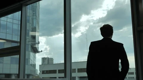 Silhouette of a man in front of the window Видео 108430301