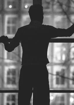 Silhouette of man in front of the window Stock Photos