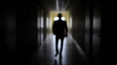 The silhouette of a man goes through the dark corridor to a bright future. Stock Footage