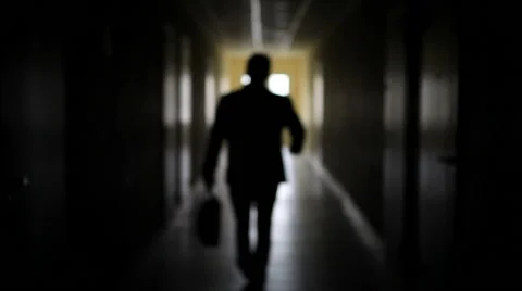 The silhouette of a man goes through the dark corridor to a bright future. Stock Footage 62846805