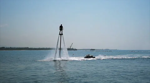 Silhouette of a Man Having Fun on Flyboard in the Sea. Vídeo Stock 67988019