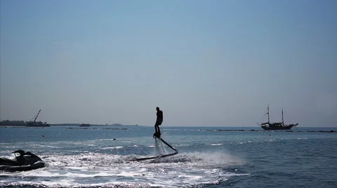 Silhouette of a Man Having Fun on Flyboard in the Sea. Vidéo 68023407
