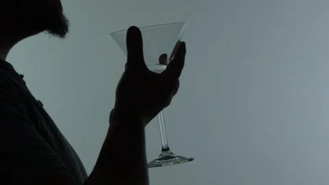 Silhouette of man having martini Video stock 103415868