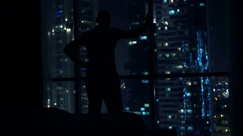 Silhouette of man having problems with sleep, waking up and standing by window Stock Footage 71147455