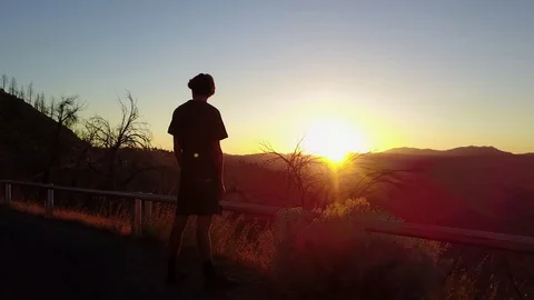 Silhouette Man Looking at Sunset in Mountains Stock Footage 83220950