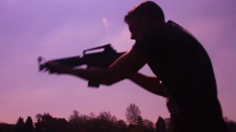 Silhouette man with m4 spin and aim Stock Footage 48897530