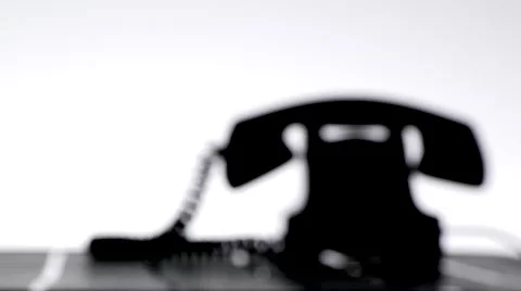 Silhouette of man making a call on old dial phone Stock Footage 67387372