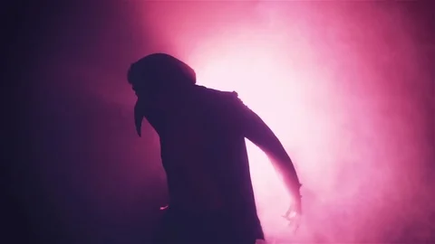 Silhouette of man in mask dancing in smoke Stock-Footage 80598106
