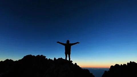 Silhouette of Man on Mountaintop at Sunset Stock Footage 284297570