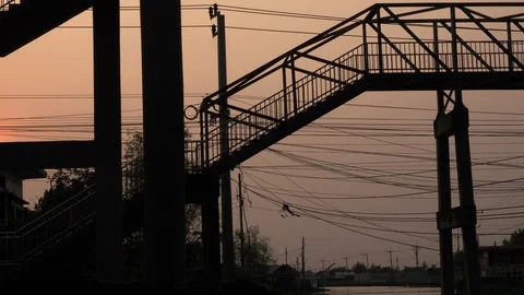 Silhouette of man or engineer is wearing constructor helmet crossing the overpas Stock Footage 130017965
