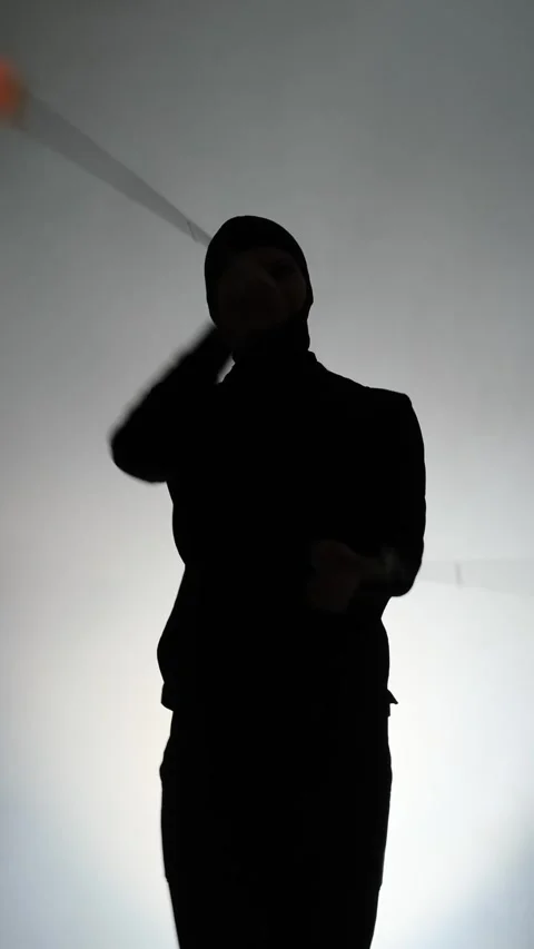 Silhouette of a Man Performing a Light Show with Glowing LED Poi Stock Footage 328127475