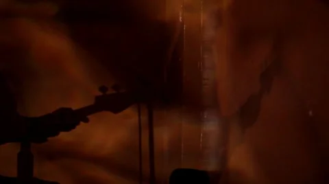 Silhouette of a man playing guitar Stock Footage