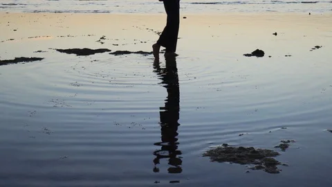 Silhouette of man practicing the elements of qigong at sunset by the sea Stock Footage 126000360