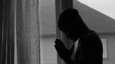 Silhouette of man praying at window Video stock 154705283