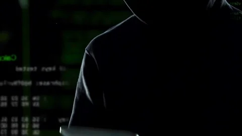 Silhouette of man quickly typing code on tablet, running lines in background Stock Footage 85170536