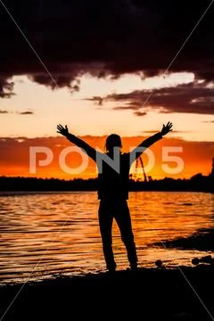 Silhouette of Man Raising His Hands or Open arms when sun rising up Stock Photos