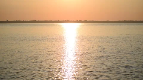 Silhouette of man rowing in small rubber boat at dawn Video stock 67437305