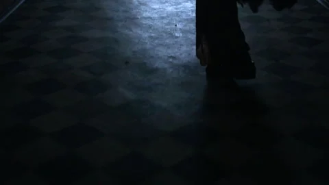 Silhouette of man running across tile floor along dark corridor to light at end Stock Footage 150211248