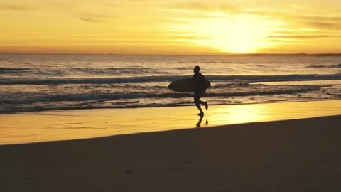 Silhouette of man running on beach at su... | Stock Video | Pond5