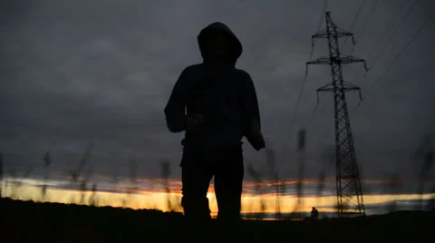 Silhouette of a man running on sunset Stock Footage 25895705