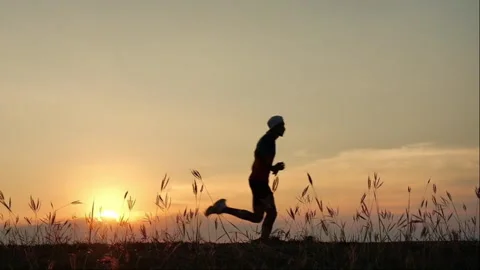 Silhouette Man running at sunset Stock Footage 266995666