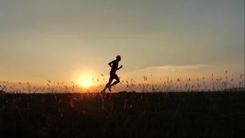 Silhouette Man running at sunset Stock Footage 266995823
