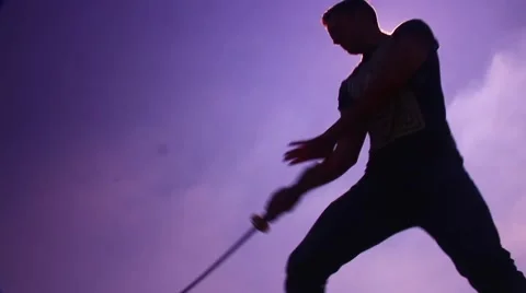 Silhouette man with samurai sword spin and slice Stock Footage 48897426
