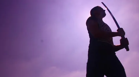 Silhouette man with samurai sword spin and slice Stock Footage 48897438