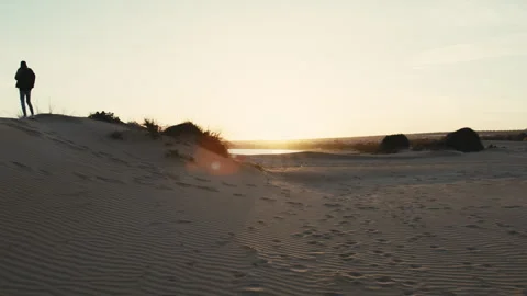 Silhouette of a Man On A Sand Dune At Sunset Stock Footage 270312722