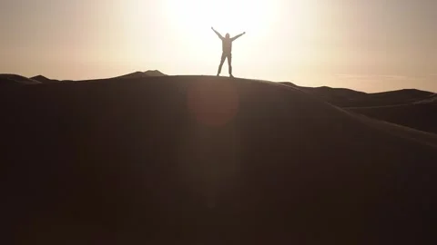Silhouette of the man stand dune during sunrise Stock Footage 288716463