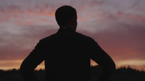 Silhouette of a Man Standing Outside at ... | Stock Video | Pond5