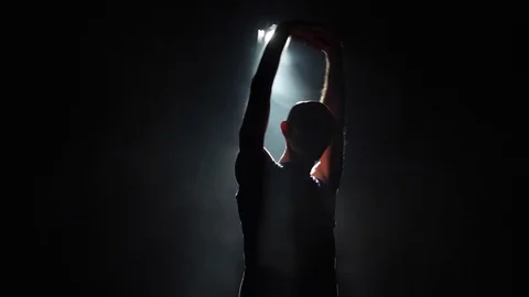 Silhouette of man stretching Stock Footage 82660259