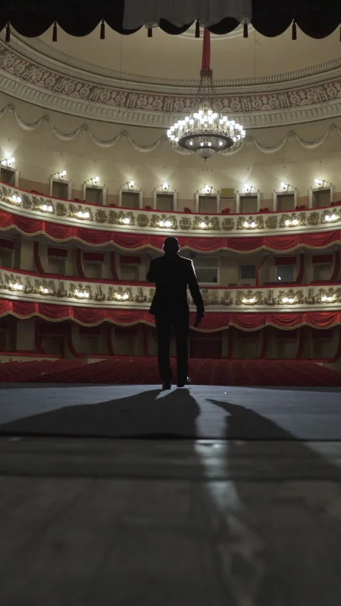 Silhouette of a man in a suit on the stage of an empty theater. Stock Footage 280668767