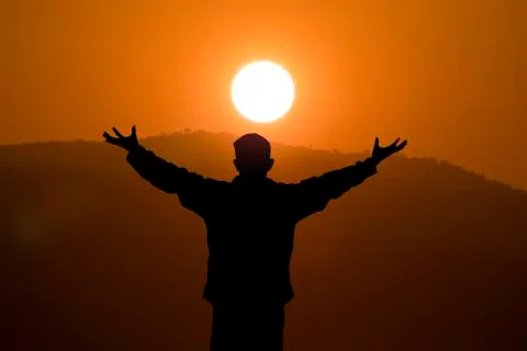 Silhouette of man on the sunset Stock Photos