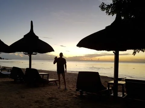Silhouette of a man at sunset Stock Photos