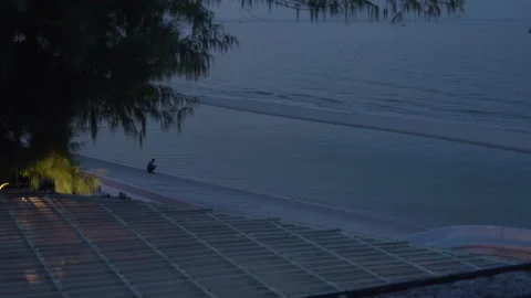 Silhouette of Man Texting on Smartphone at Beach at Night 스톡 동영상 337534444