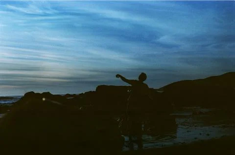Silhouette of Man Throwing Stock Photos