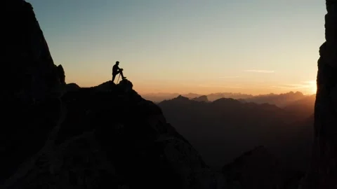 Silhouette of a man on the top of the mountain Stock Footage 131337196
