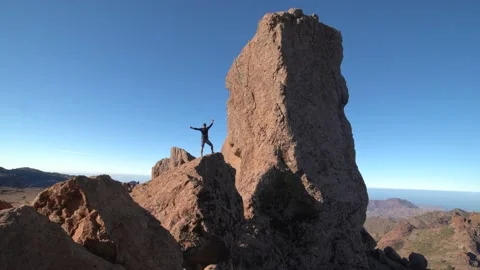 Silhouette of a man on top of Roque Nublo. Gran canaria Stock Footage