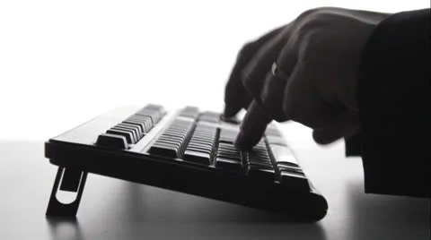 Silhouette of man typing on computer keyboard Stock Footage 22971043