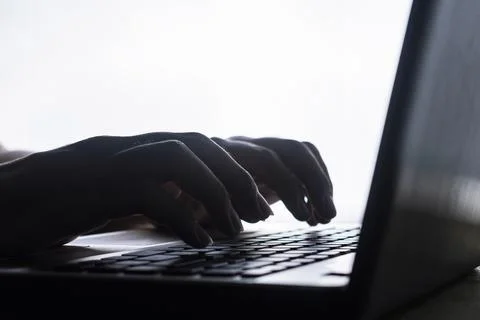 Silhouette man typing Stock Photos