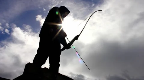 Silhouette of man using bow and arrow, archery Stock Footage 49079161