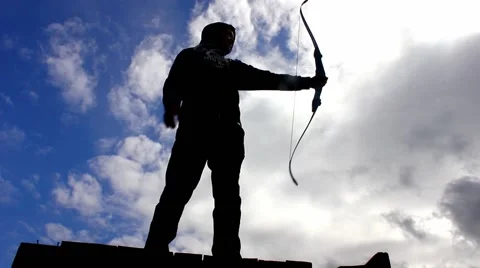 Silhouette of man using bow and arrow, archery Stock Footage 49079176