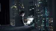 Silhouette Of Man Using Laptop And Falling Asleep On Bed At Night At Home, 4K Stock Footage