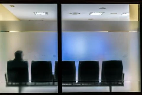 Silhouette Of Man Waiting Alone In Empty Hospital Waiting Room Stock Photos